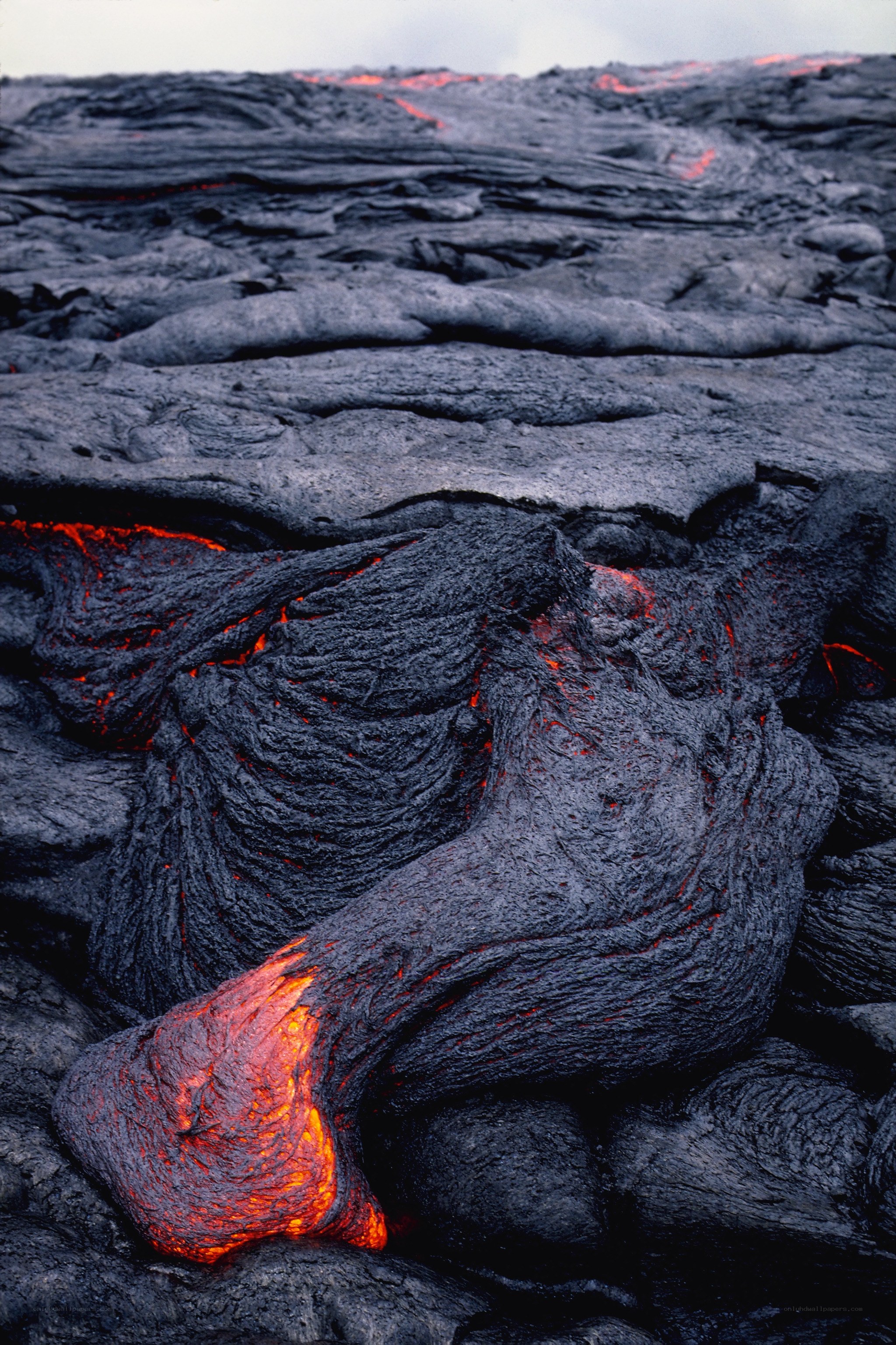 Flowing lava on volcanic landscape