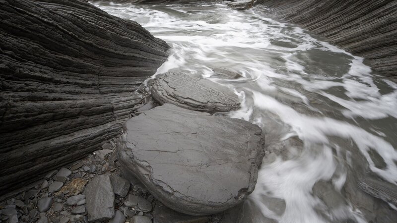 Flowing water over layered rocks