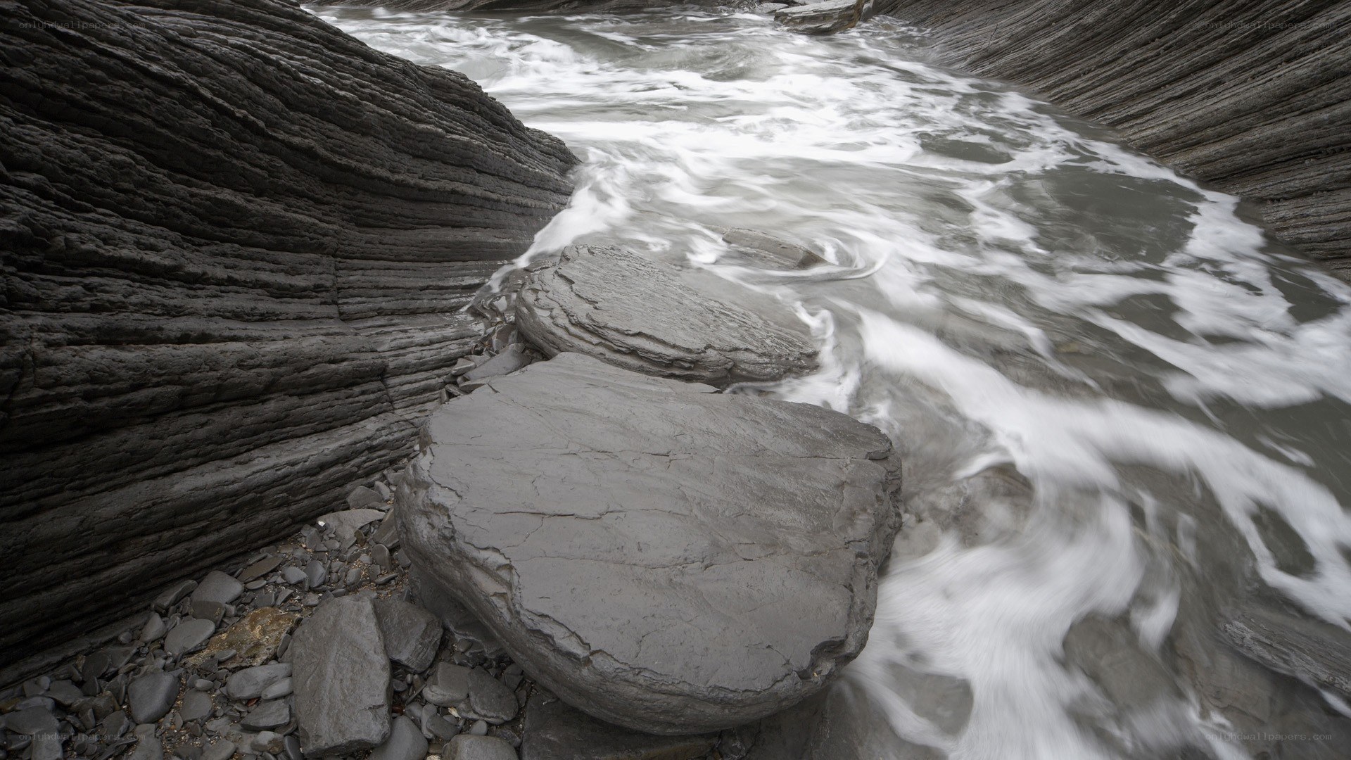 Flowing water over layered rocks