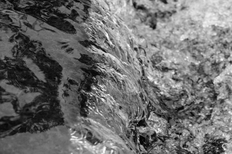Flowing Water over Rocks — Black