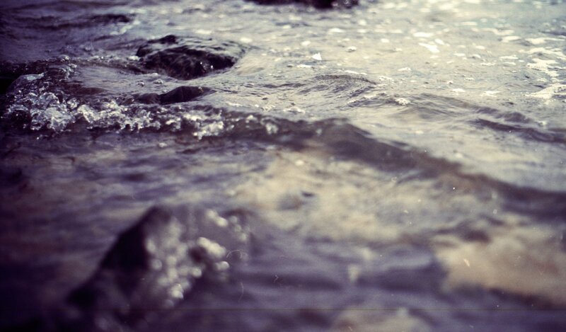 Flowing Water over Rocks — Gray