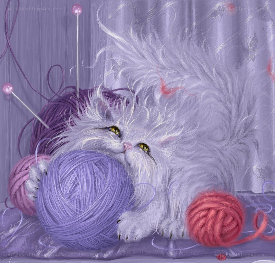 fluffy cat with yarn balls