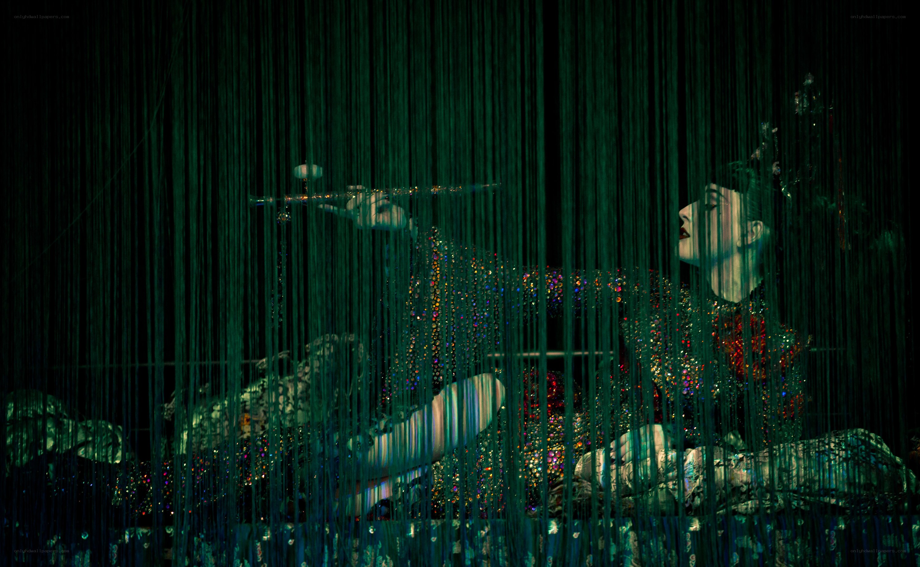 Flute player behind green curtain