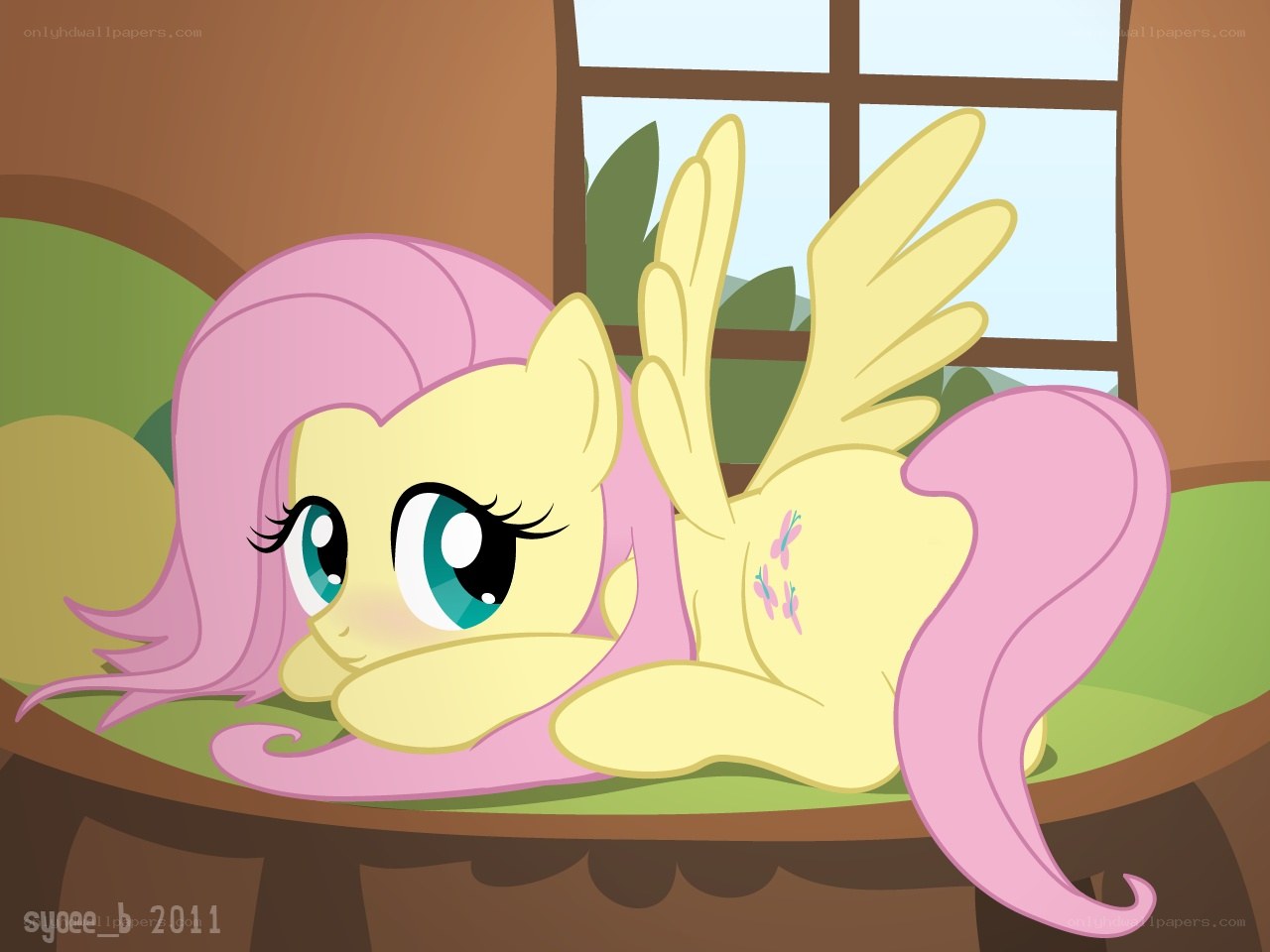 Fluttershy resting on a bed