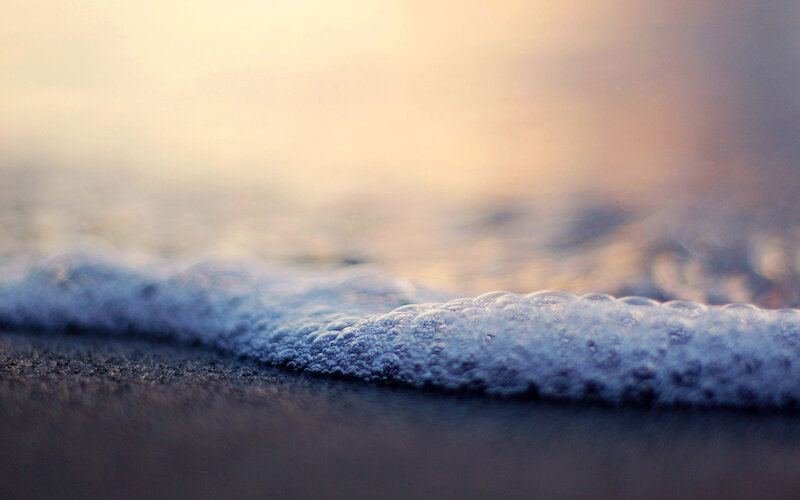 foamy wave at sunset