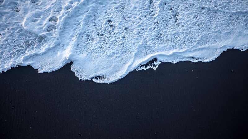 Foamy Wave on Black Sand