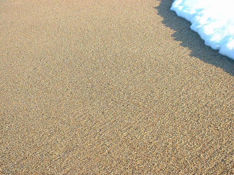 foamy wave on sandy beach