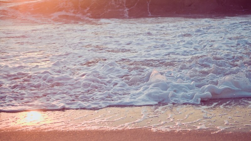 foamy waves at sunset
