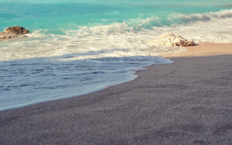 foamy waves on a sandy beach