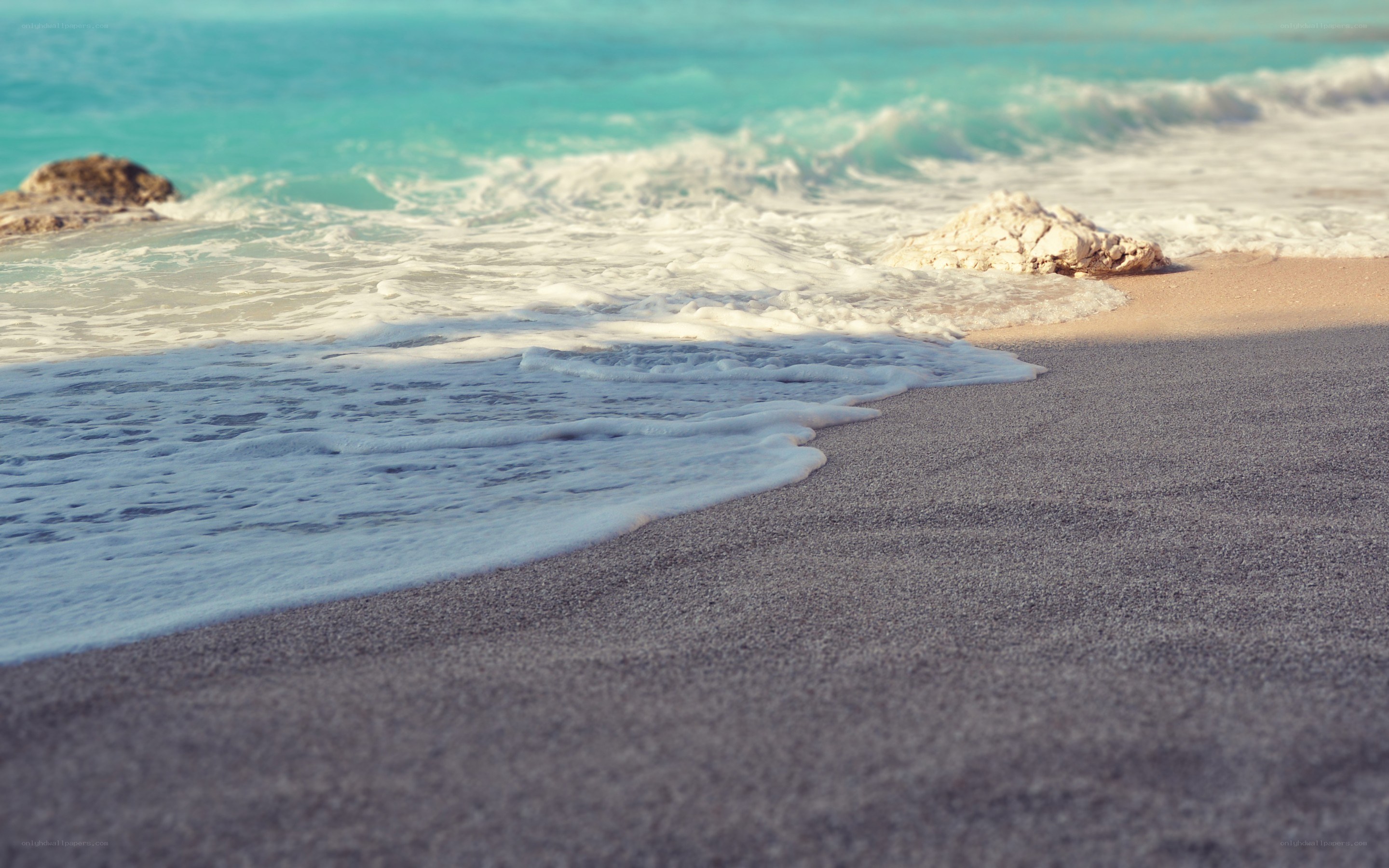 foamy waves on a sandy beach
