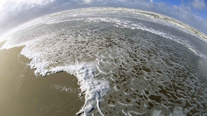 foamy waves on a sandy beach