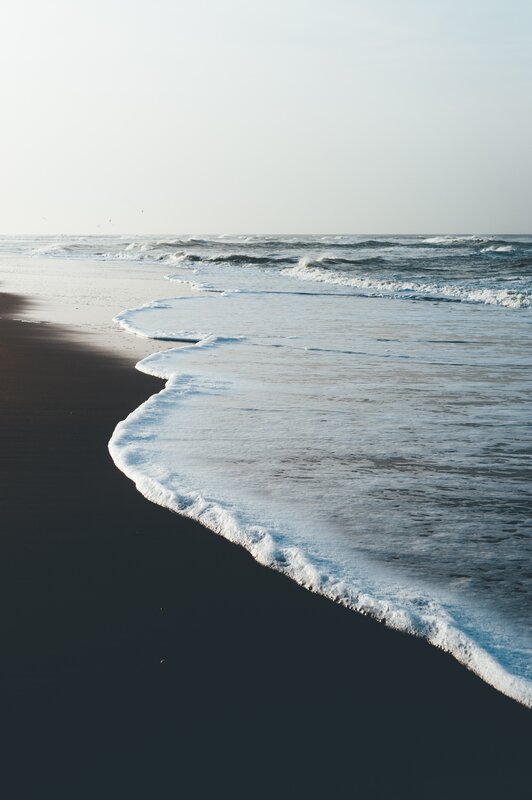 Foamy Waves on Dark Sand
