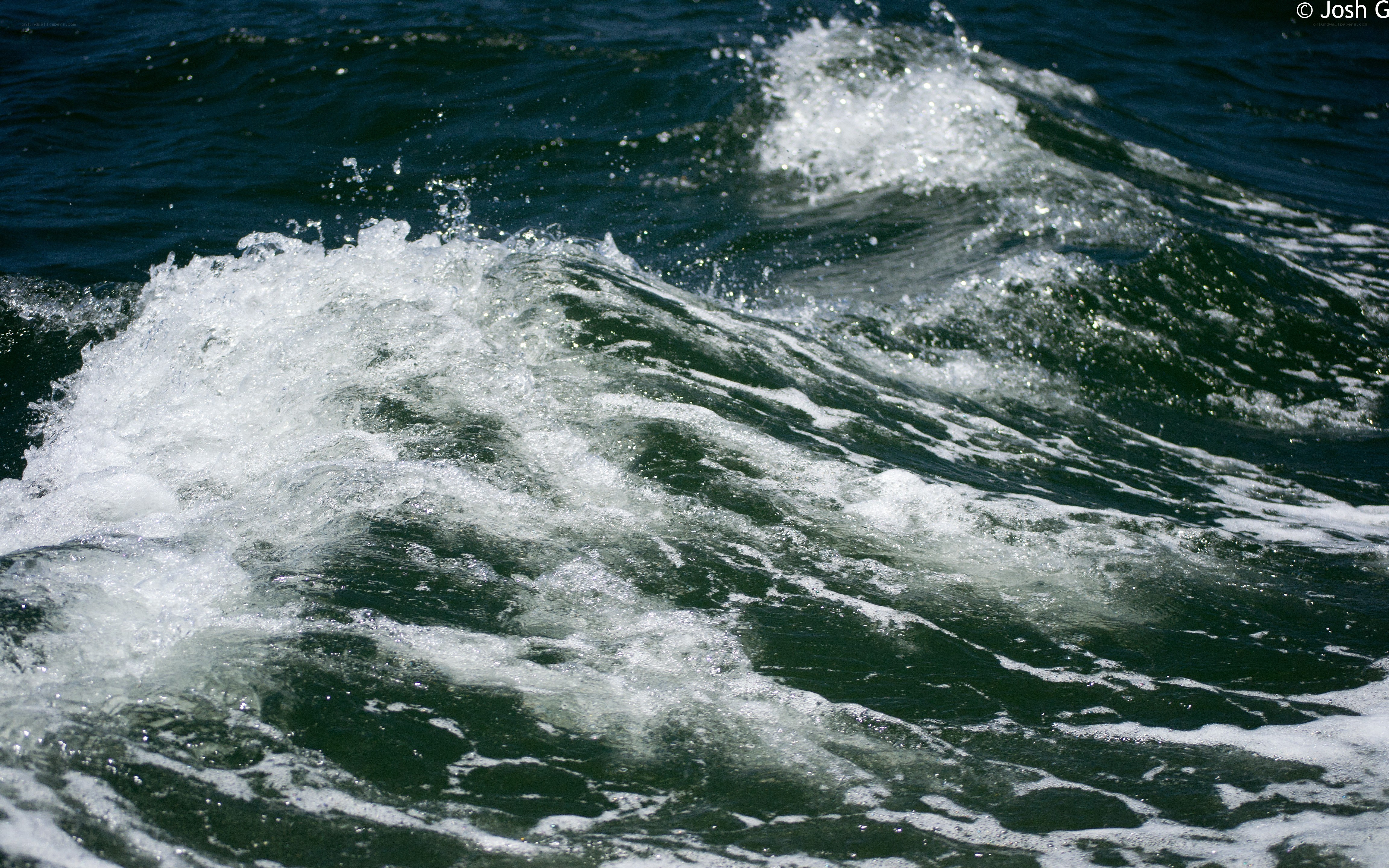 foamy waves on dark water