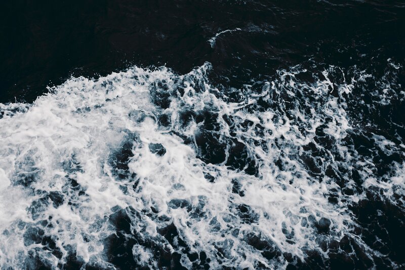 foamy waves on dark water