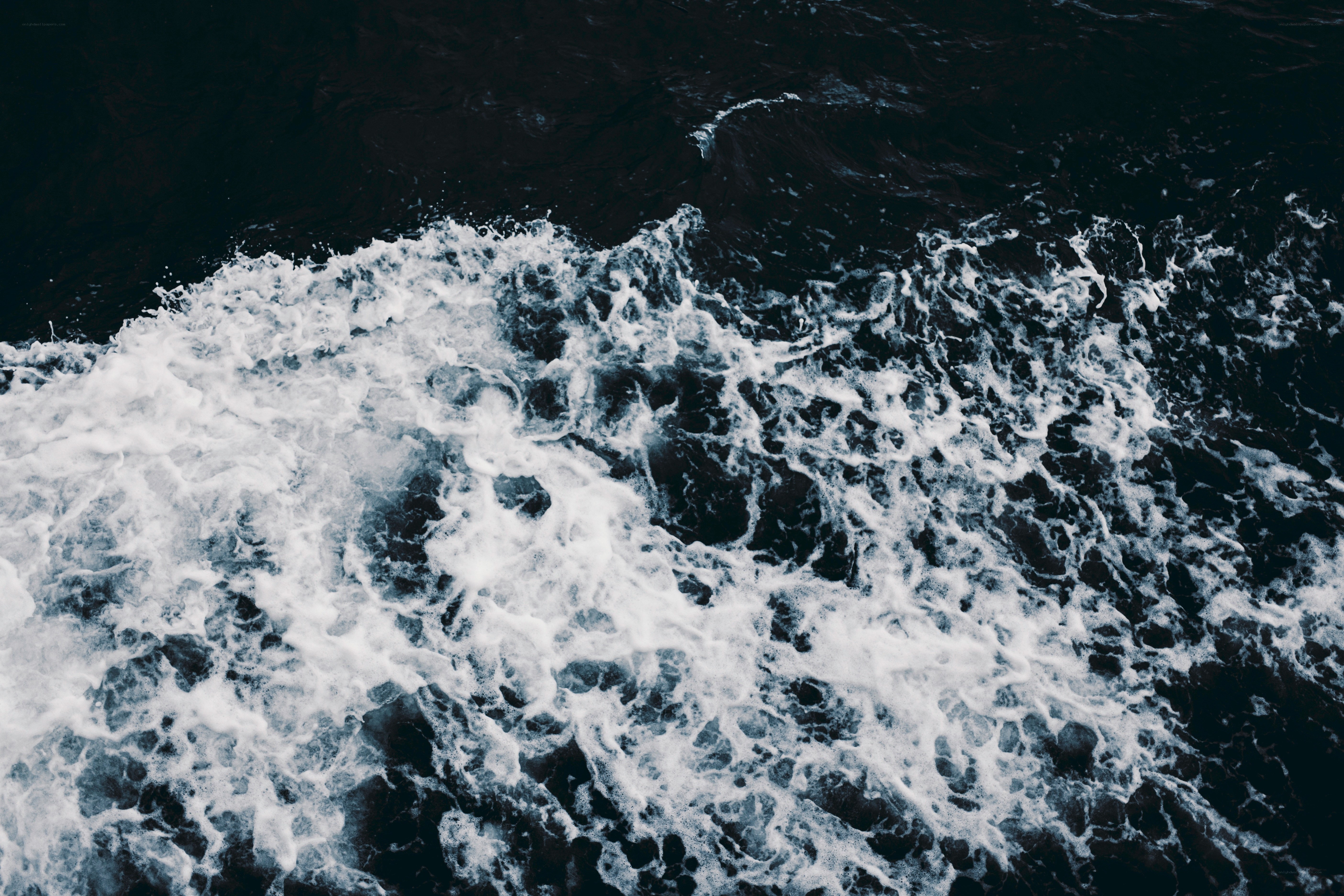 foamy waves on dark water