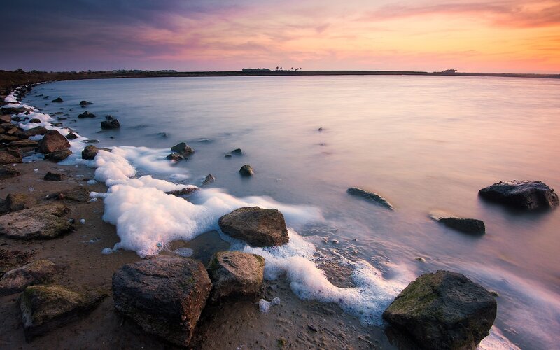 Foamy Waves on Rocky Shore — Purple, Serene, Sunset