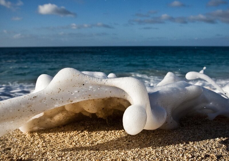 Foamy waves on sandy beach