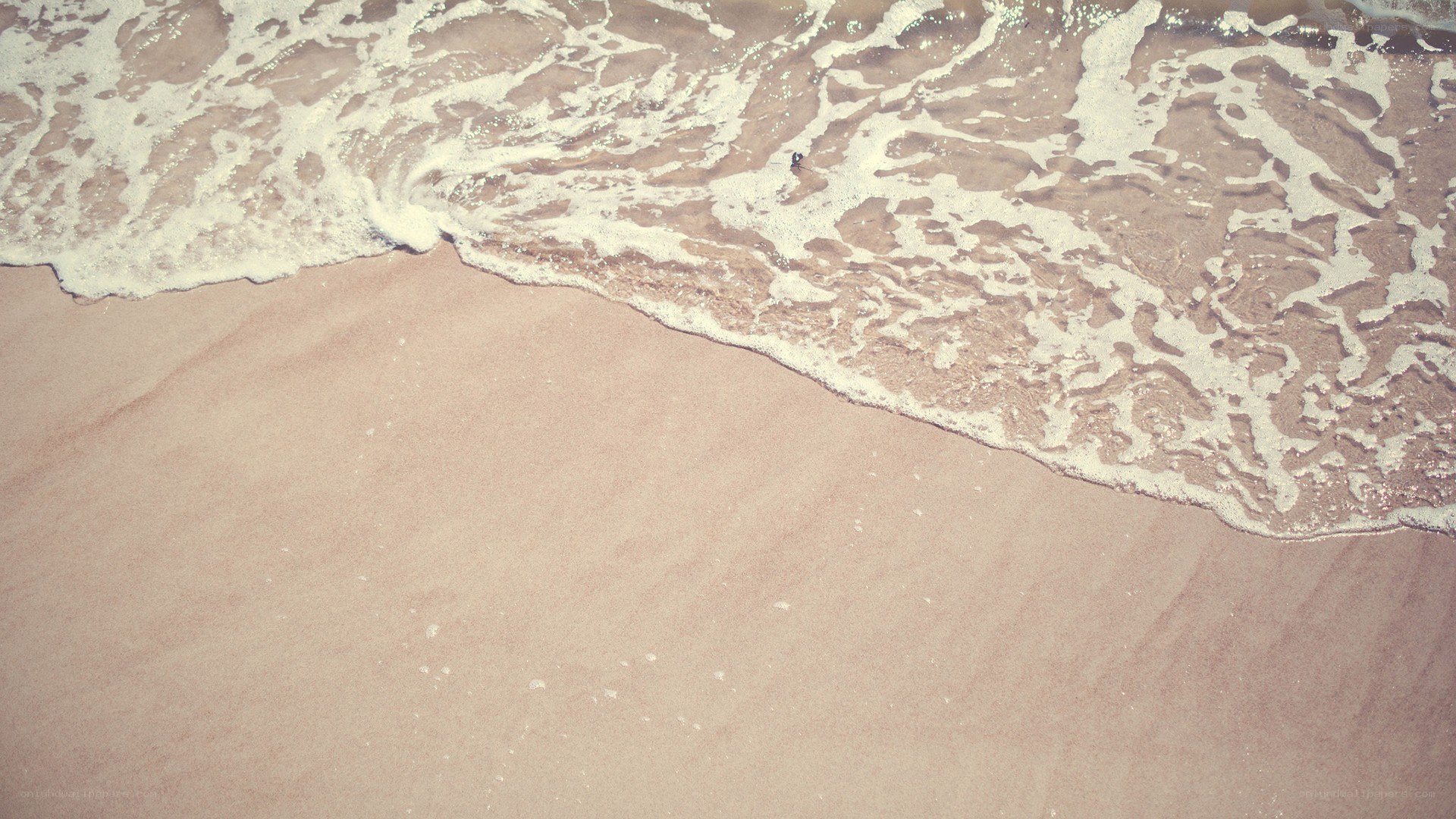 foamy waves on sandy beach