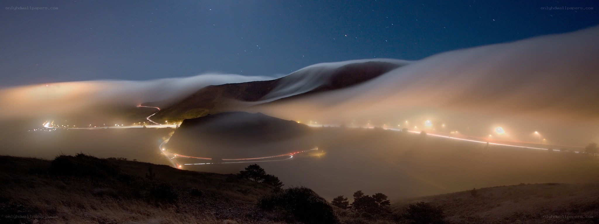 Fog over winding coastal road