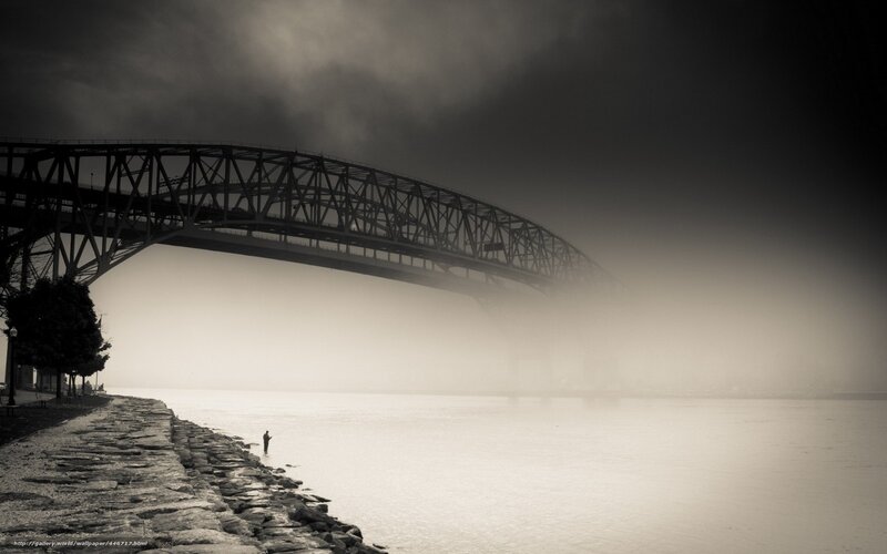 Foggy bridge and lone fisherman