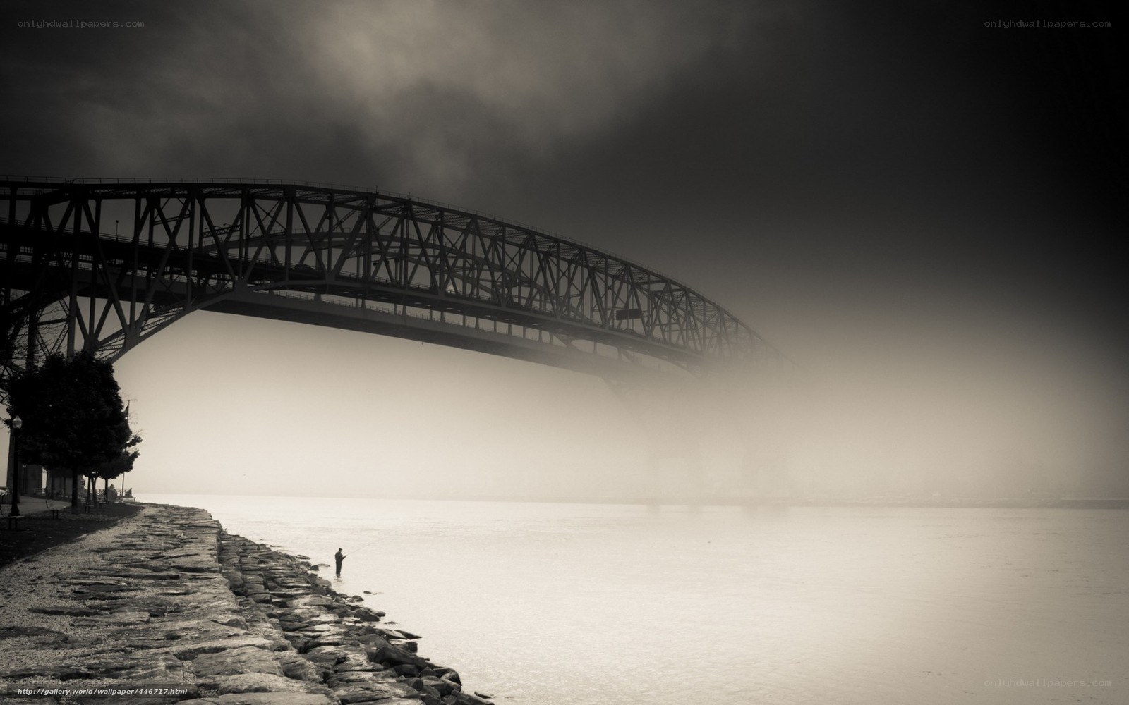 Foggy bridge and lone fisherman