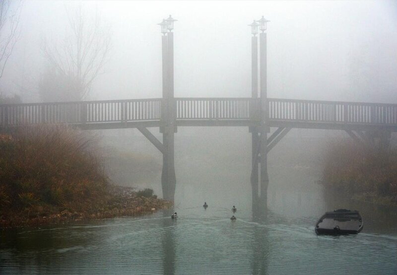 Foggy bridge over a river