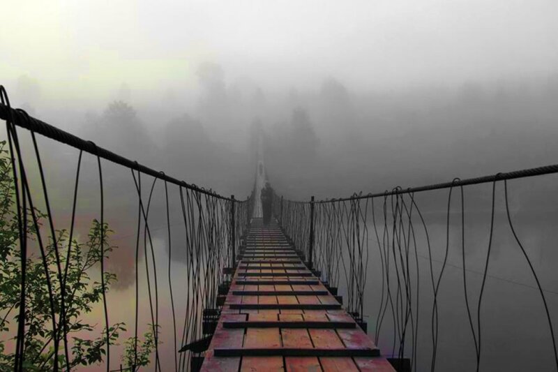 Foggy bridge over river