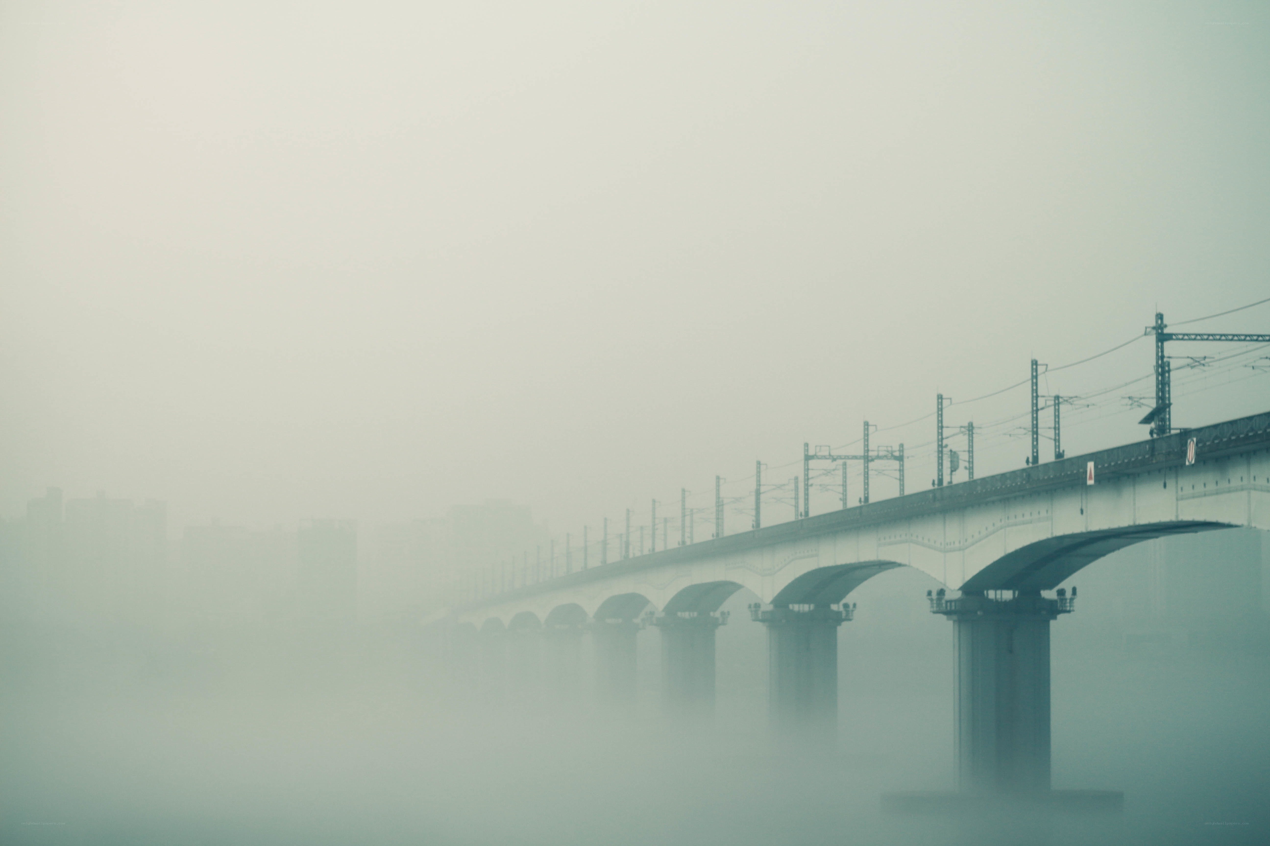 Foggy bridge over river