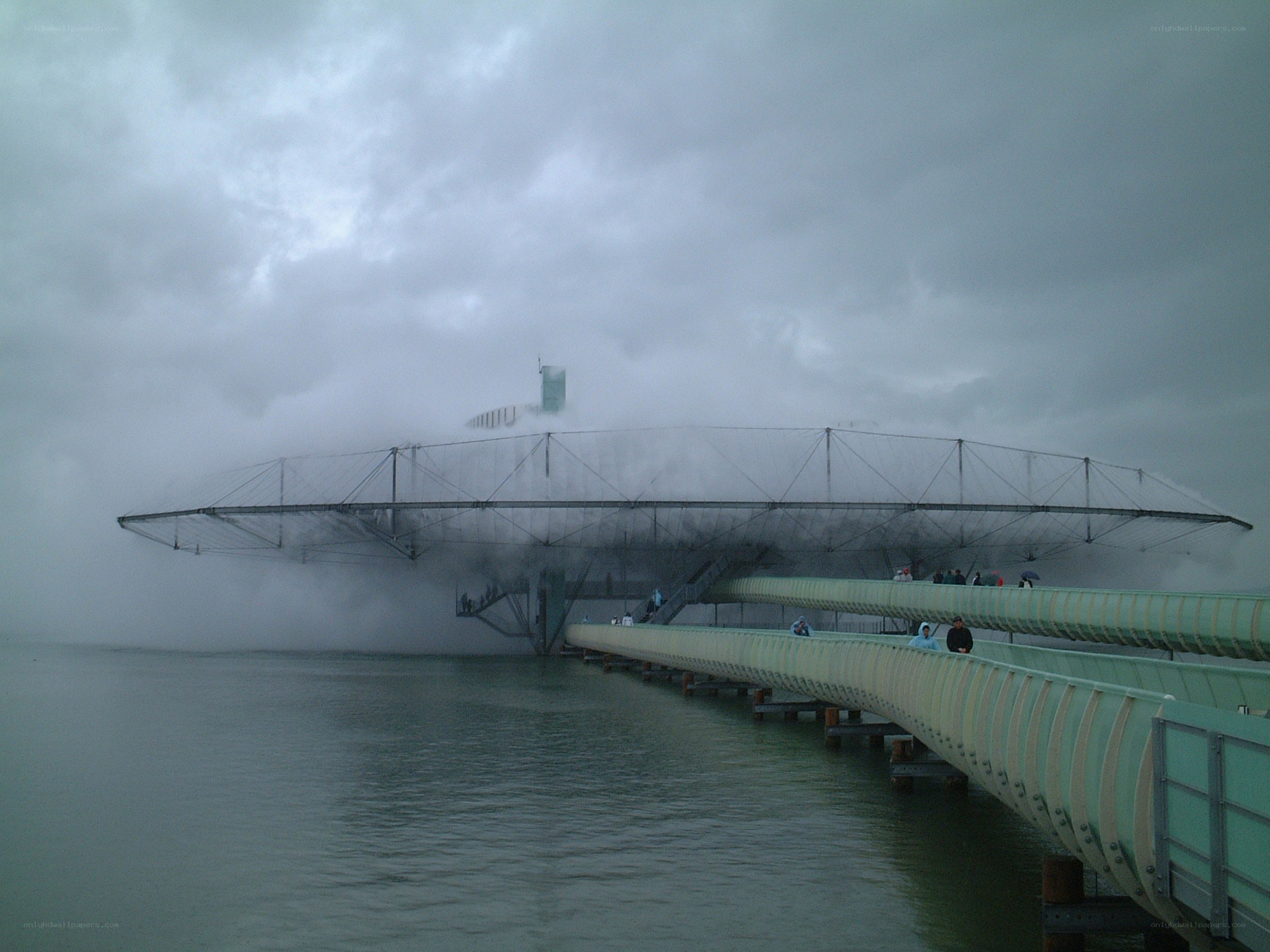 Foggy bridge over water