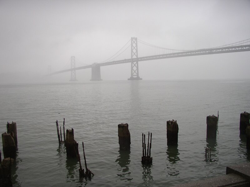 foggy bridge over water