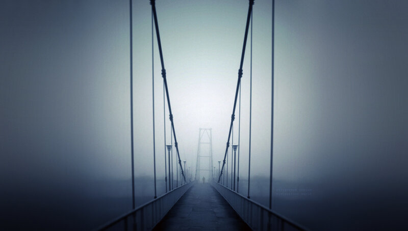 Foggy bridge with lone figure
