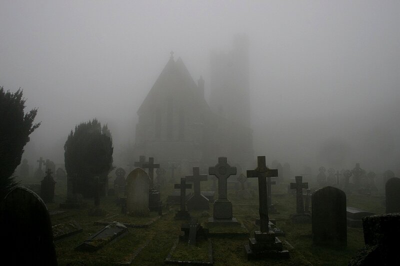Foggy cemetery with church