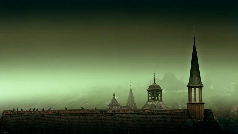 Foggy church spires at dawn