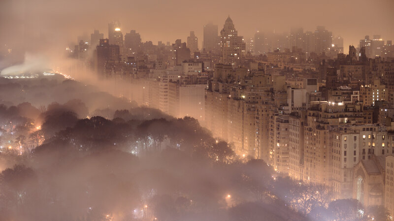 Foggy city skyline at night