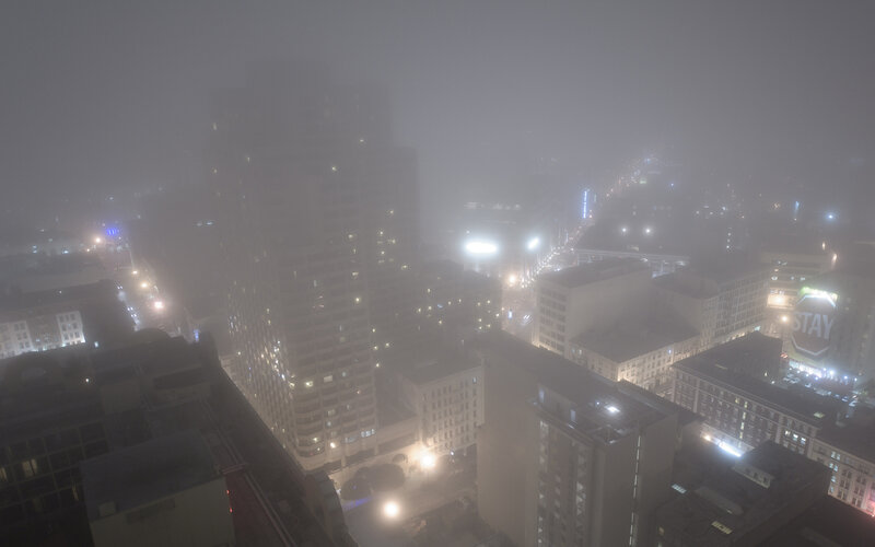 Foggy city skyline at night