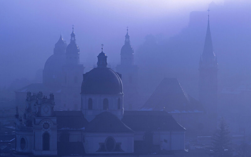 Foggy city with church domes