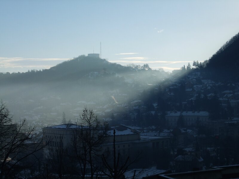 Foggy cityscape with sunbeams