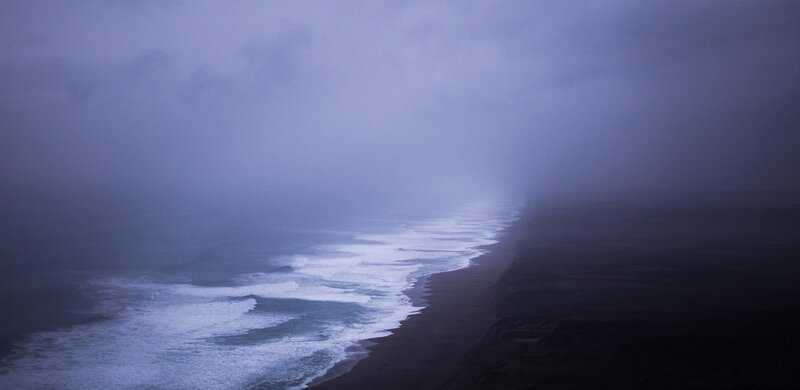 foggy coastal shoreline