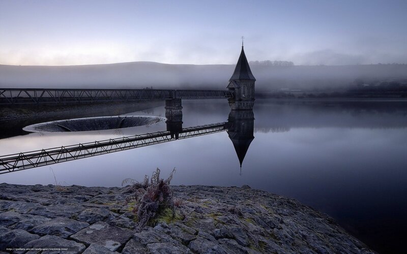 Foggy dam with tower reflection