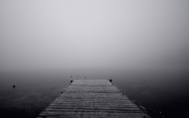 Foggy dock on a calm lake