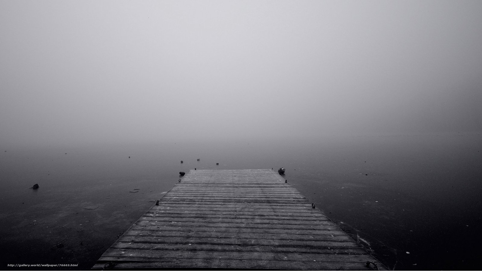 Foggy dock on calm water
