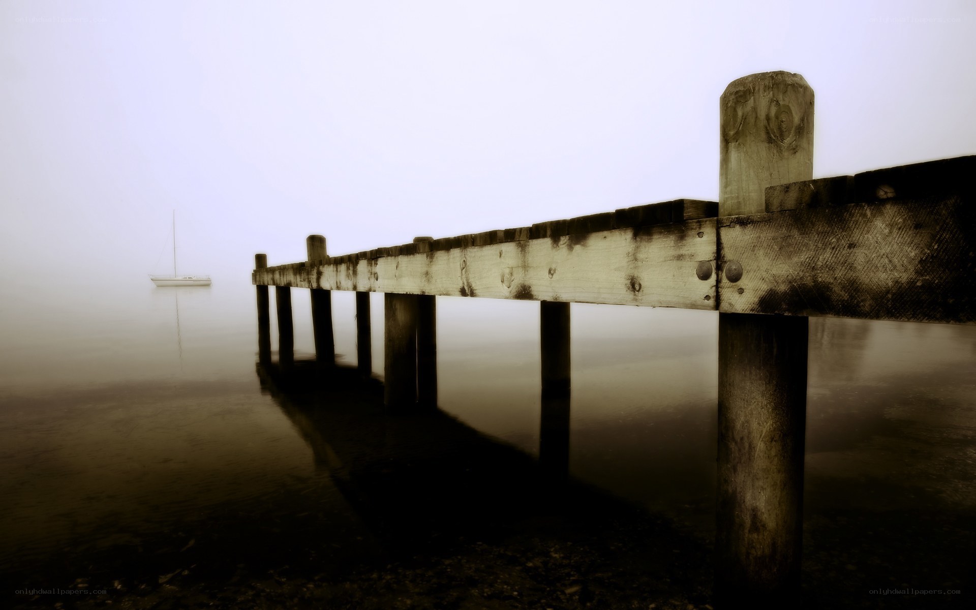 Foggy dock with sailboat