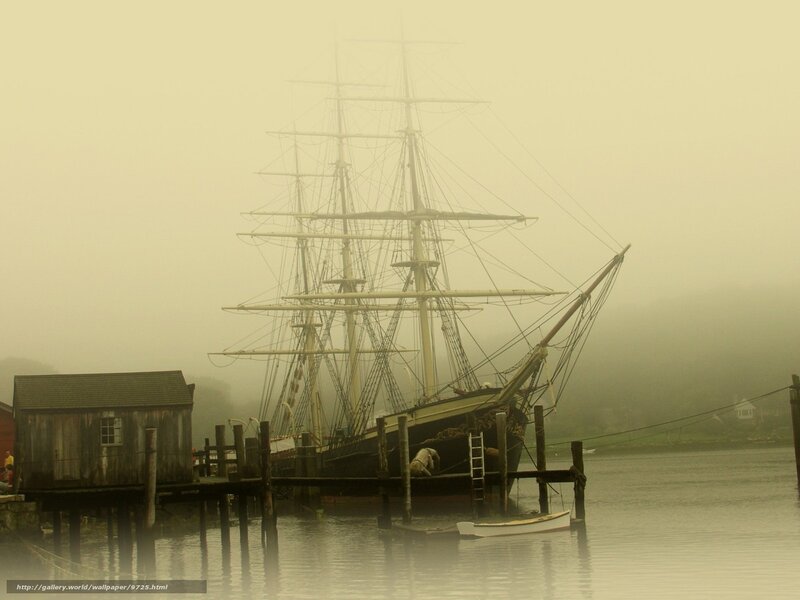 Foggy harbor with tall ship