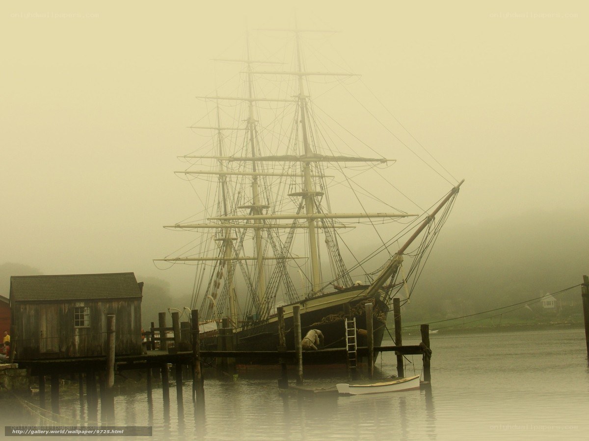 Foggy harbor with tall ship