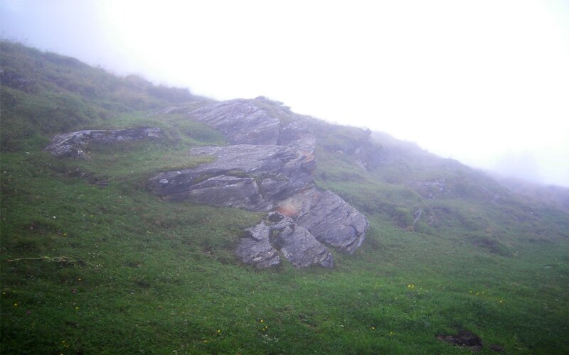 Foggy hillside with rocks