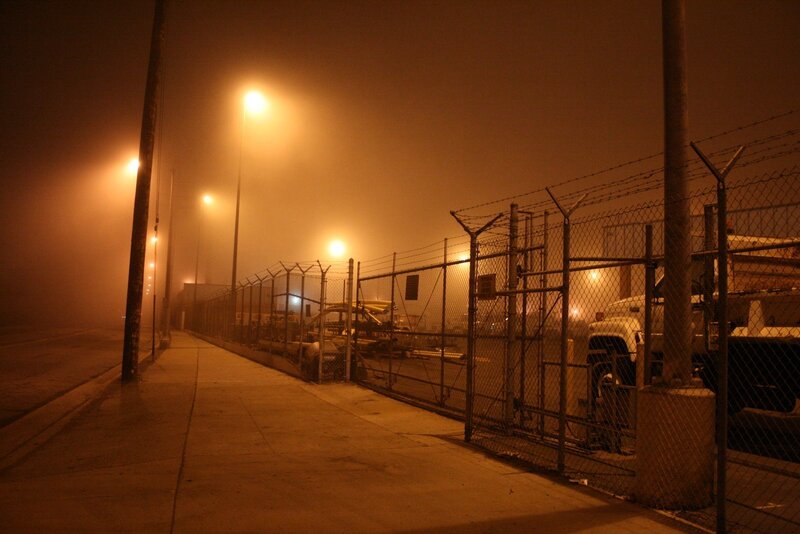 Foggy industrial street at night