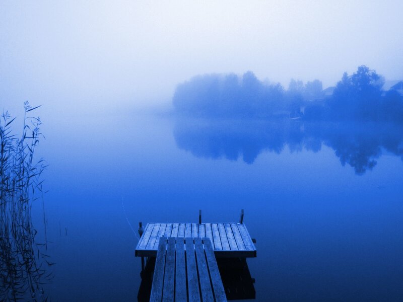 Foggy lake dock at dawn
