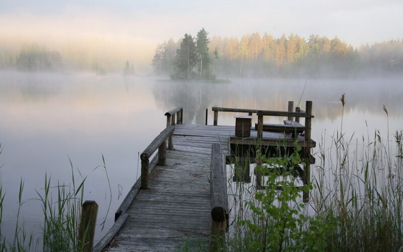 Foggy lake dock at dawn