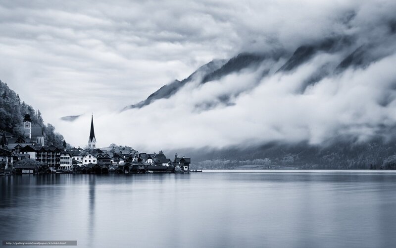 Foggy lake town with church