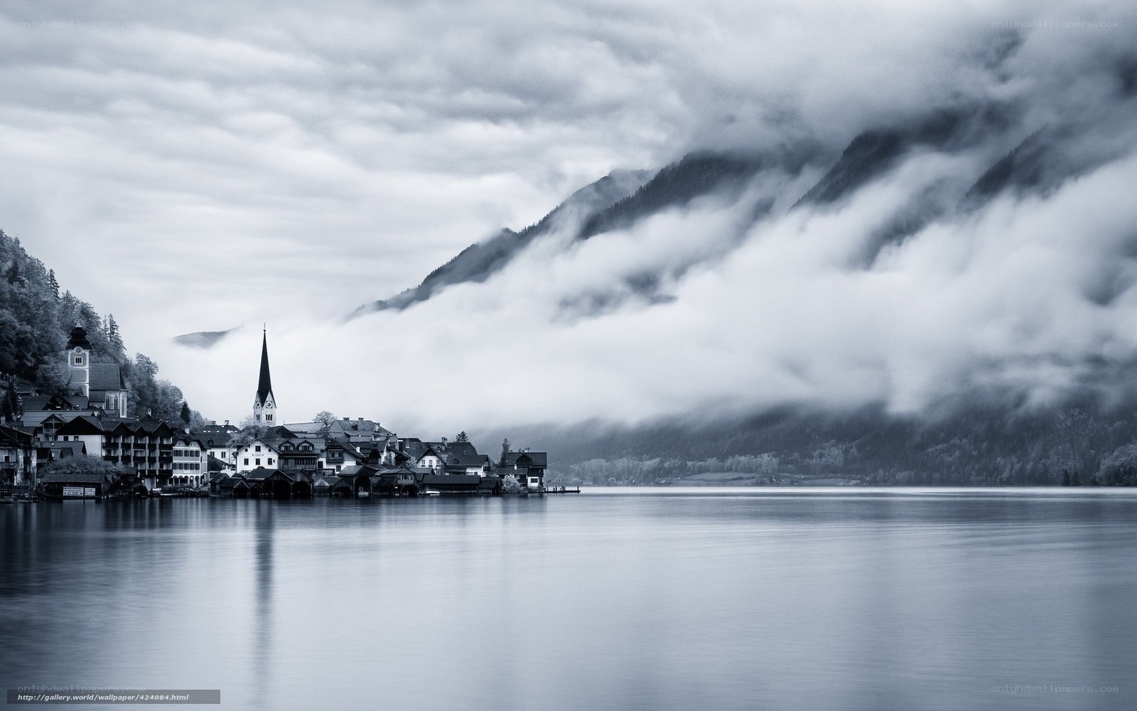 Foggy lake town with church